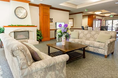 Interior lounge area with cozy furniture and floral arrangement