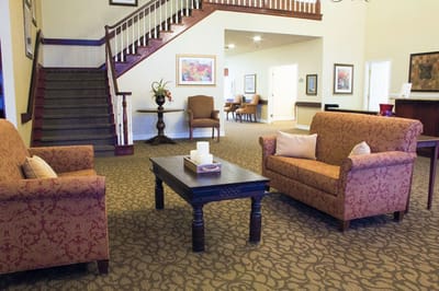 Cozy lounge area with seating and staircase