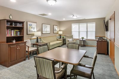 Cozy common area with seating and bookshelf