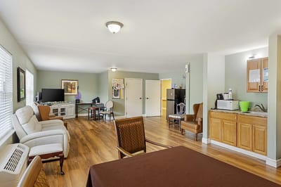 Bright common area with seating and kitchenette
