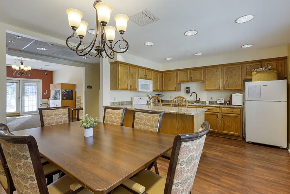 Bright common area with dining table and kitchen