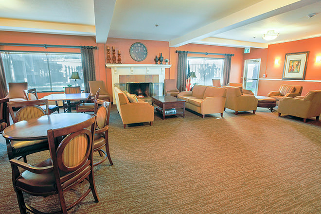 Bright common area with seating and a fireplace