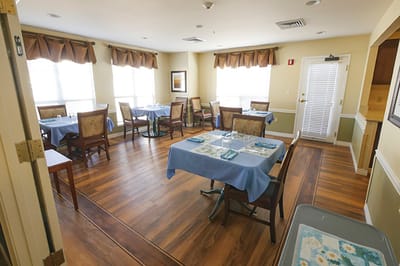 Bright dining room with tables set for meals