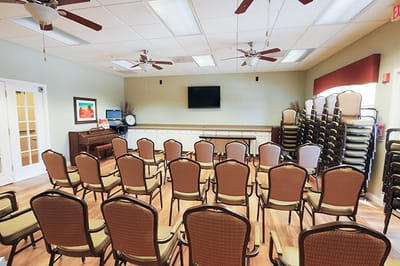 Interior view of a seating area with chairs arranged for an event