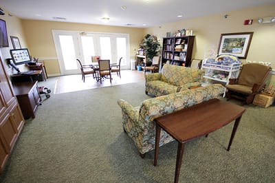 Common area with seating and tables in a senior living facility