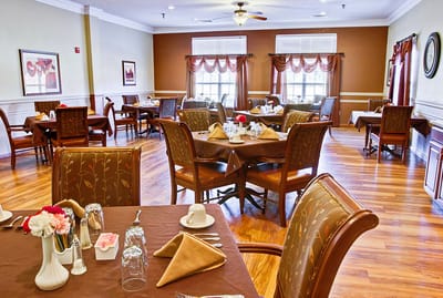 Dining area with neatly set tables and chairs