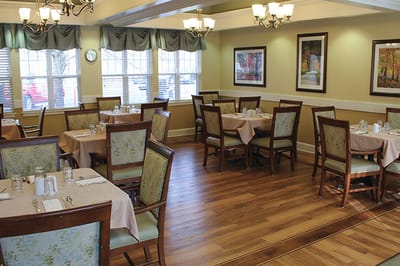 Dining room set up for residents with tables and chairs