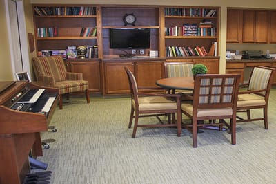 Cozy common area with seating and bookshelves