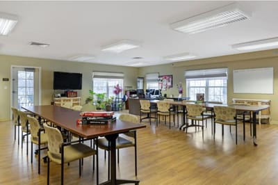 Interior view of a common activity room with tables and chairs