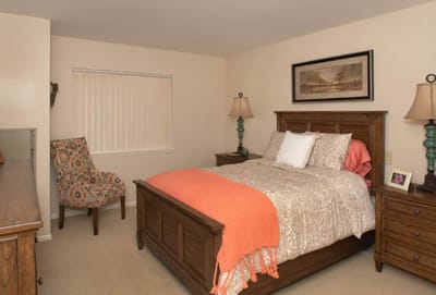 Brightly furnished resident bedroom with a cozy aesthetic