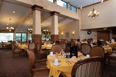 Bright dining room with set tables for meals