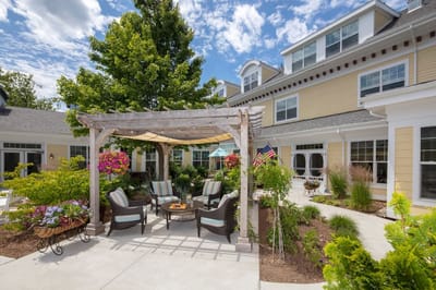 Outdoor seating area with gardens and seating under a pergola