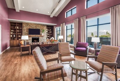 Bright common area with seating and large windows