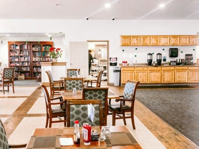 Bright dining area with tables and bookshelf