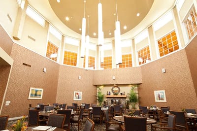 Bright dining room with large windows and elegant decor