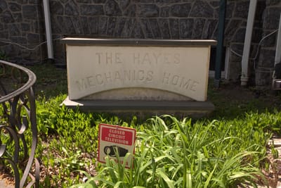 Sign for Hayes Mechanics Home surrounded by greenery