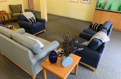 Cozy seating area in a common room with fish tank