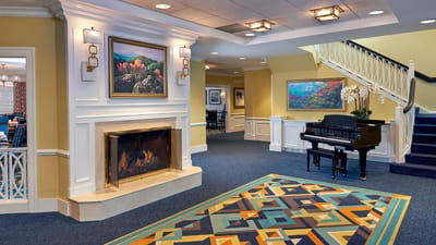 Interior lobby area with a fireplace and piano