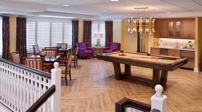 Bright interior common area with a pool table and seating