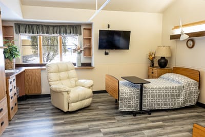 Cozy resident room with a bed and recliner