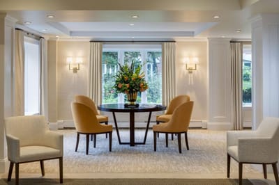 Common area with a table and chairs, floral arrangement