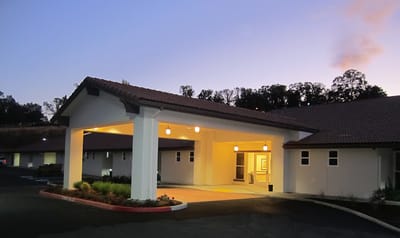 Front entrance of a senior care facility at dusk