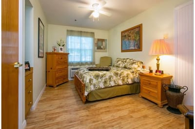 Private room with a bed and wooden furniture