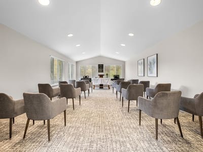 A bright activity room with seating arranged