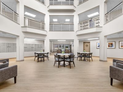 Common area with seating and tables in a bright interior space