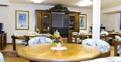Bright dining area with wooden tables and floral chairs