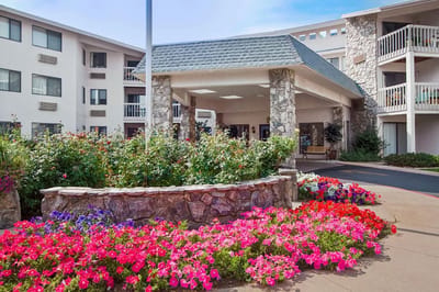 Exterior view of the facility entrance with colorful flowers