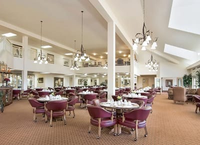 Indoor dining area with round tables and elegant lighting