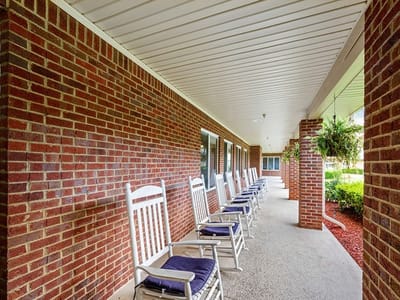 Interior corridor with rocking chairs and brick walls