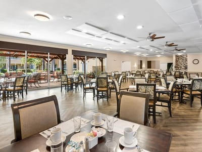Dining room setup with tables and outdoor views