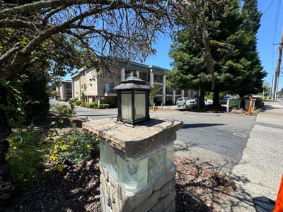 Exterior view of the facility building with landscaped entrance