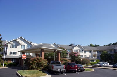 Exterior view of Dogwood Terrace with parking and flowers
