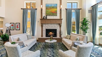 Bright common area with comfortable seating and fireplace