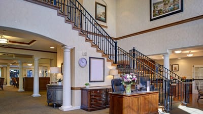 Interior view of a welcoming lobby with staircase and reception desk