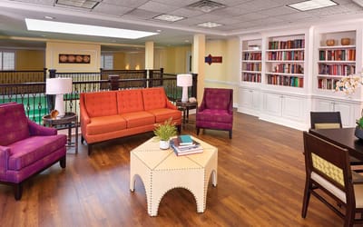 Bright common area with colorful seating and bookshelves