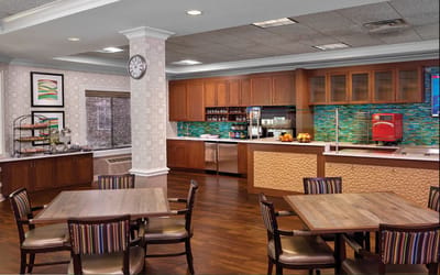 Interior view of the dining area with tables and kitchen