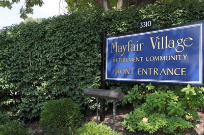 Signage for Mayfair Village Retirement Community's front entrance