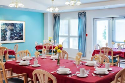 Dining area set up for a meal with tables and decor