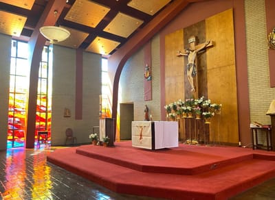 Interior of a chapel with altar and stained glass