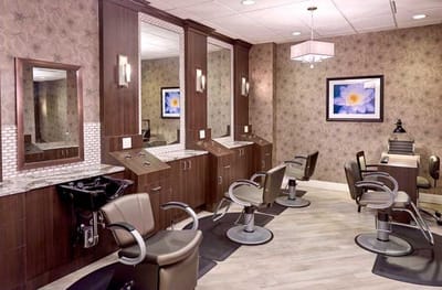 Beauty salon area with styling chairs and mirrors