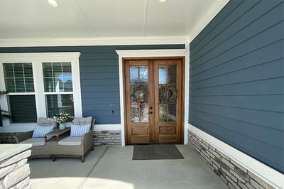 Entrance area of Southern Magnolia Living with decorative door.