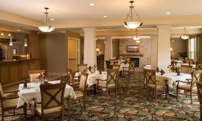 Dining area with tables and chairs in a warm setting