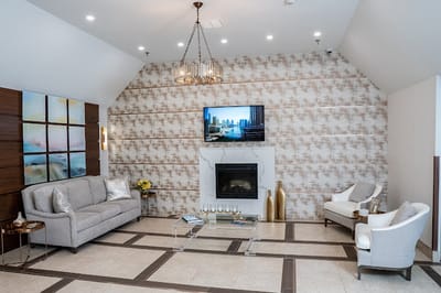 Bright common area with comfortable seating and a fireplace