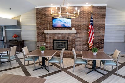 Bright common area with seating and a fireplace