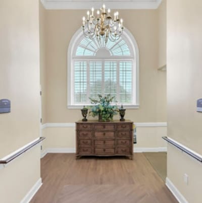 Interior hallway with decorative chandelier and window