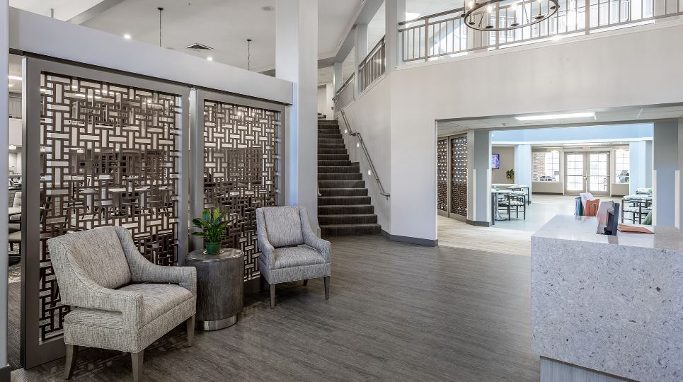 Bright common area with seating and decorative screens